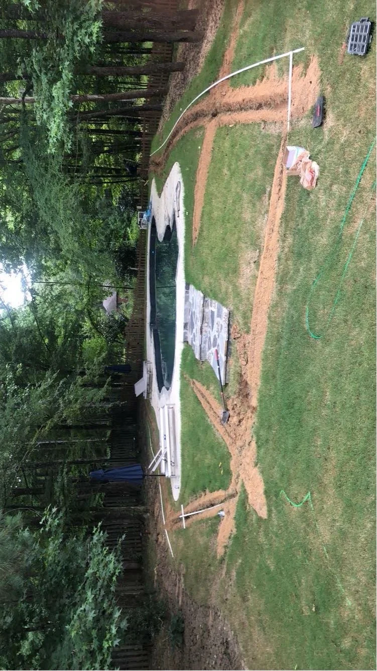 Irrigation install staged around a pool property in Oxford MS by Oxford Lawn Pro