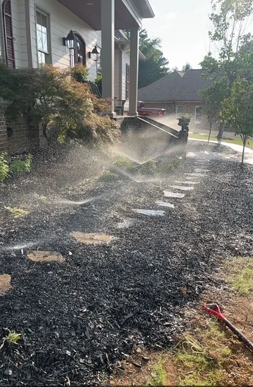 Oxford Lawn Pro irrigation system actively running across a residential mulched landscape in Oxford, MS